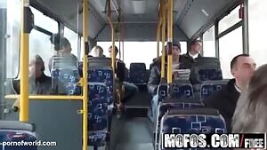 The couple has sex on the bus. Passengers are nearby